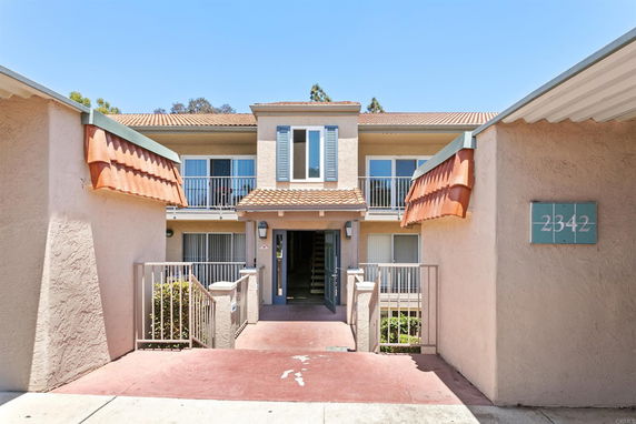 Front view of a two-story apartment building with a central entrance.
