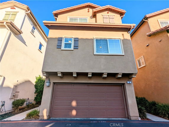 Front view of a multi-story house with a double garage.