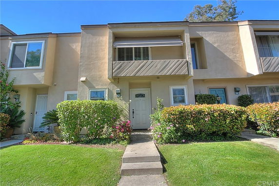 Front view of a two-story townhouse with a small balcony.