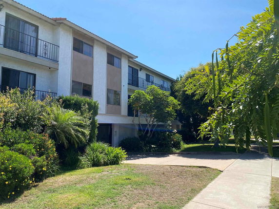 Front view of a two-story apartment building with balconies.