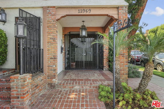 Front view of a building entrance with brick and metal gate.