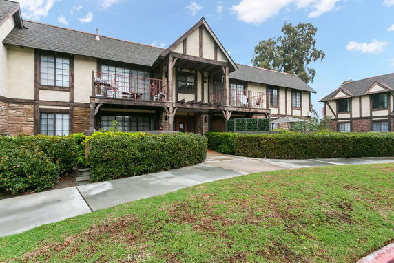 Front view of a two-story house with a traditional design and balcony.