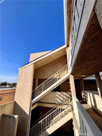 View of a multi-story building with an external staircase.