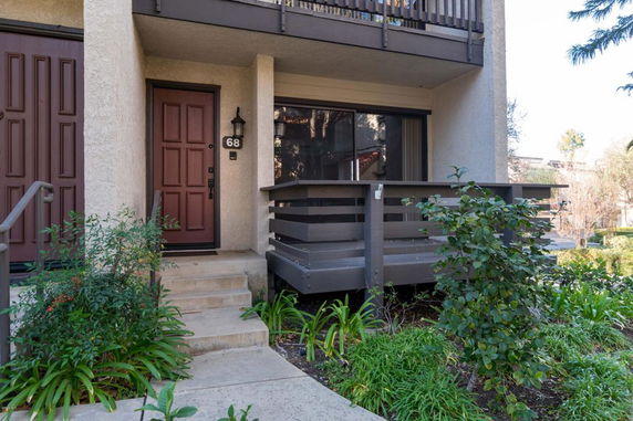 Front view of a two-story house with a small porch and balcony.