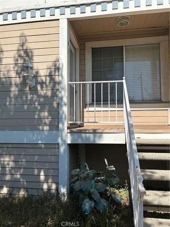 Front view of a house with a small porch and stairs