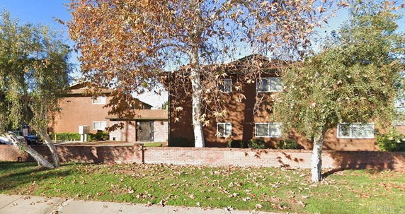 Front view of a two-story building with a brick exterior wall.