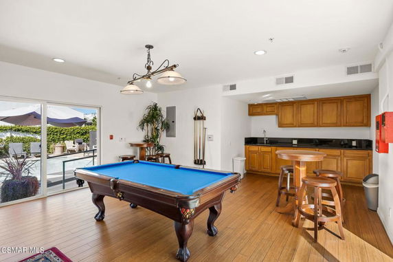 Indoor recreation area with pool table and seating.