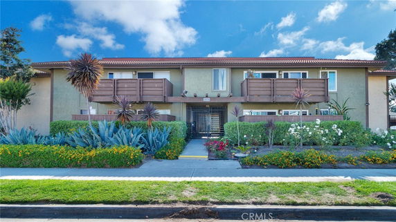 Front view of a two-story residential building with balconies.