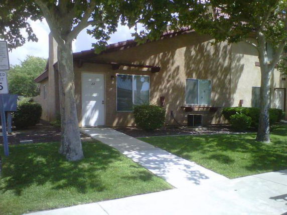 Front view of a single-story house with a walkway and windows.