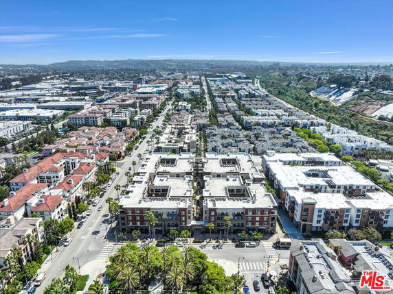 Aerial view of an urban area with multiple residential buildings and streets extending into the distance.