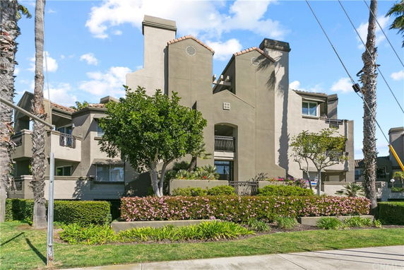 Front view of a multi-story residential building with a modern design and balconies.