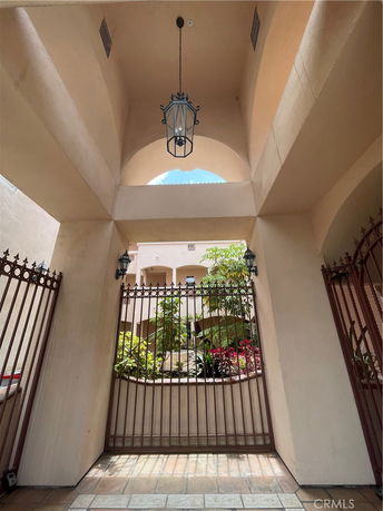 Front view of a building entrance with an iron gate and an arched design.