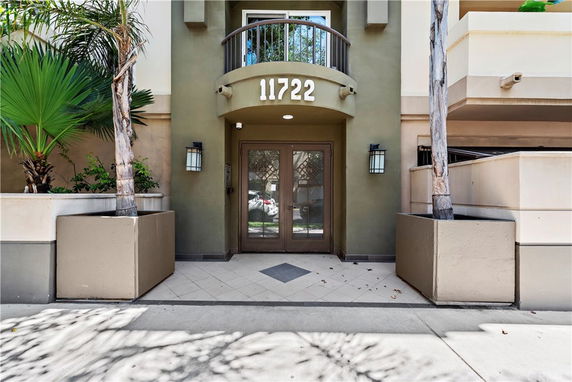 Entrance view of a building facade with number 11722 above the door.