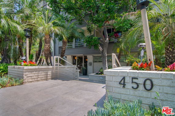 Front view of a building with a landscaped entrance and prominent street number.