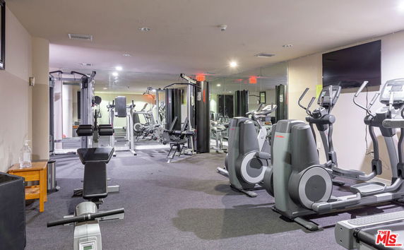 Indoor gym area with various fitness equipment and exercise machines.