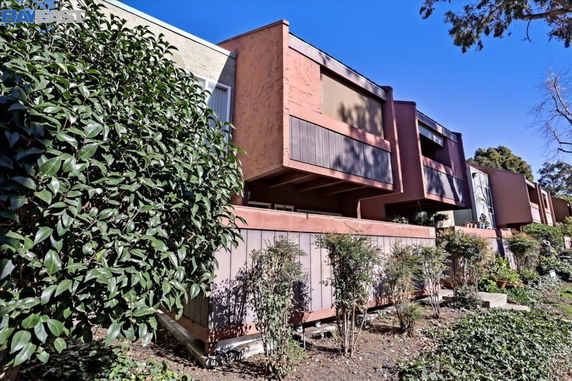 Front view of a multi-story residential building with balconies.