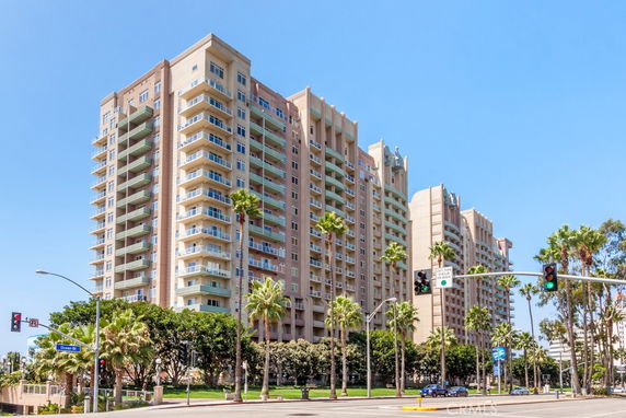 Front view of a multi-story residential building with balconies.
