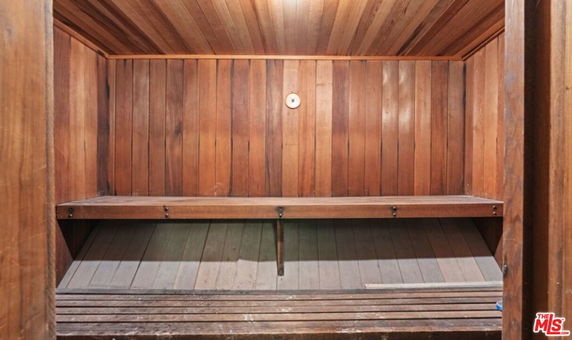 Interior view of a wooden sauna room with wooden seating.