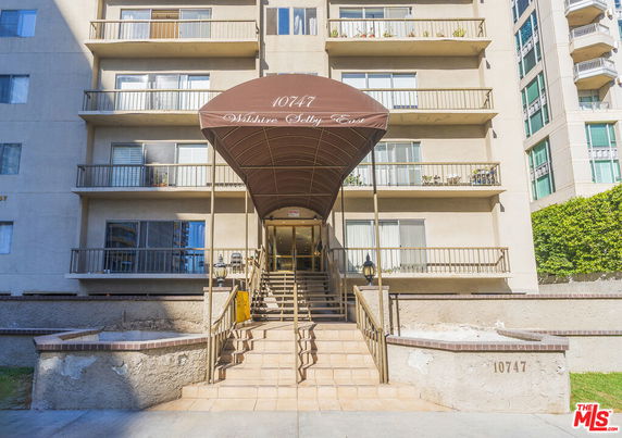 Front view of a multi-story building with a covered entrance.
