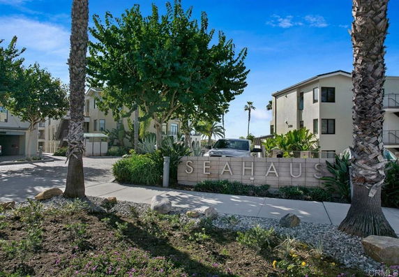 Front view of a multi-story residential complex with a sign that says 'SeaHaus'.