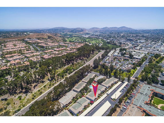 Panoramic view of a suburban area with residential buildings and roads seen from above.