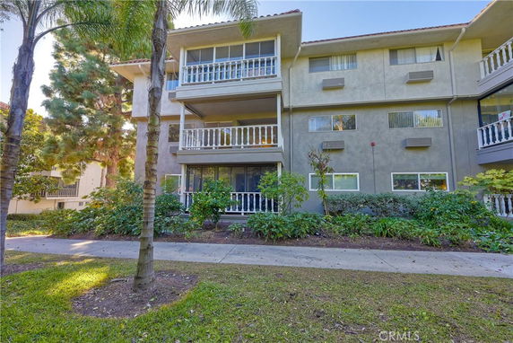 Front view of a multi-story residential building with balconies.