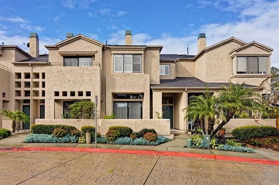 Front view of a multi-story townhouse with a modern design.