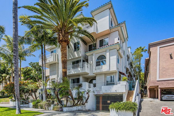 Front view of a multistory residential building with balconies.