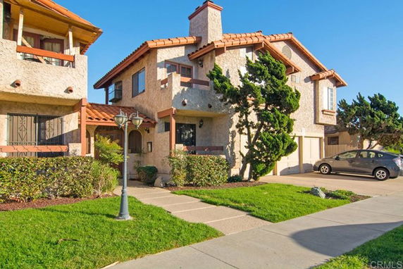 Front view of a two-story house with a textured exterior and a sloped roof.