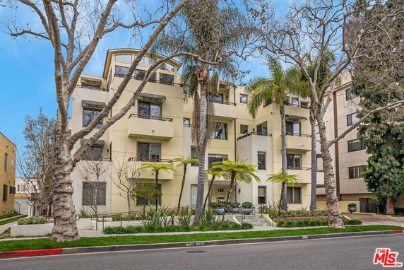 Front view of a multi-story residential building with balconies.