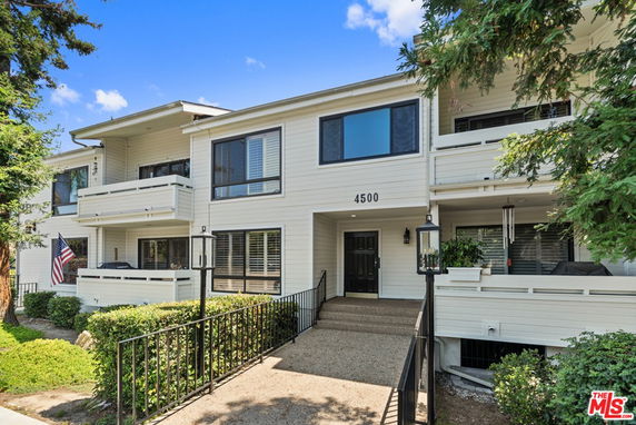 Front view of a multi-story residential building with balconies.