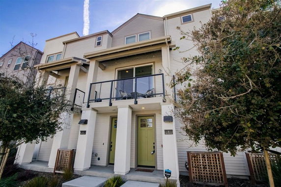 Front view of a multi-story house with a balcony.