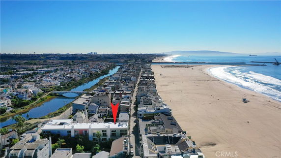 Aerial view of a coastal area with houses and a beach.