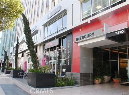 Front view of a modern multi-story building with a commercial entrance.