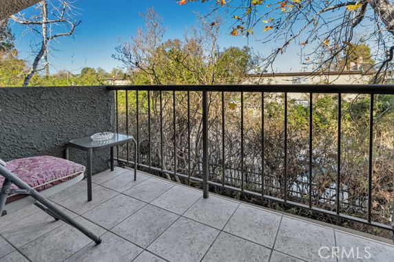 View from a balcony of trees and distant landscape.