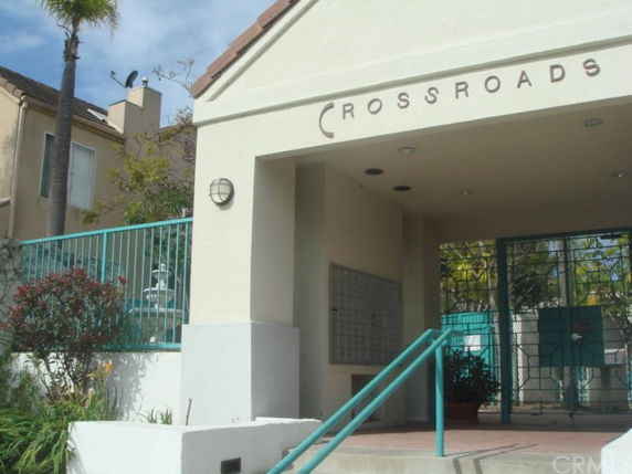 Front view of a small building entrance with the name 'Crossroads' above.