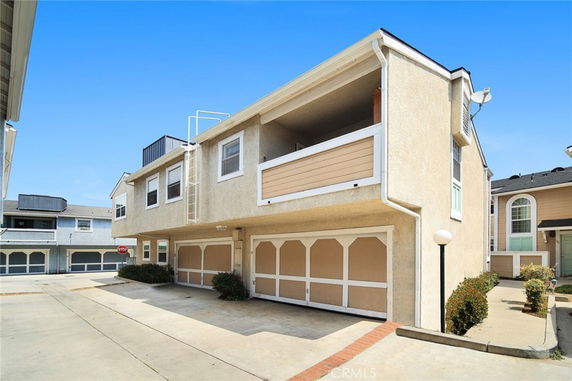 Front view of a multi-story house with a garage and balcony.