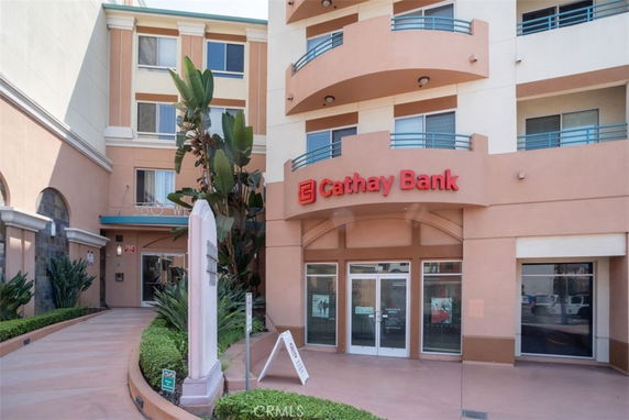 Front view of a multi-story building with a bank entrance