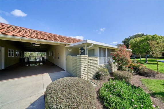 Front view of a house with a tiled roof and covered entryway.