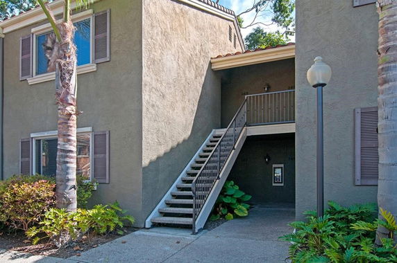 Front view of a two-story building with external stairs.