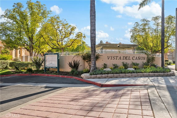 Front view of a residential complex entrance with a sign reading 'Vista Del Cañon'.