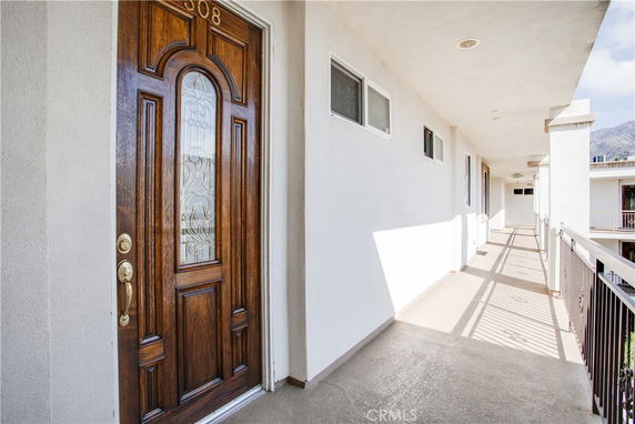 Front view of a building corridor with a wooden door.