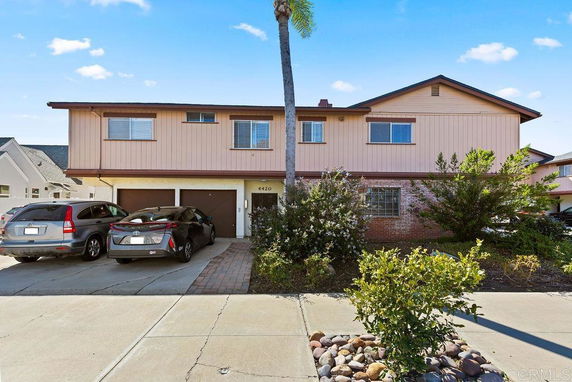Front view of a two-story house with a double garage and driveway.