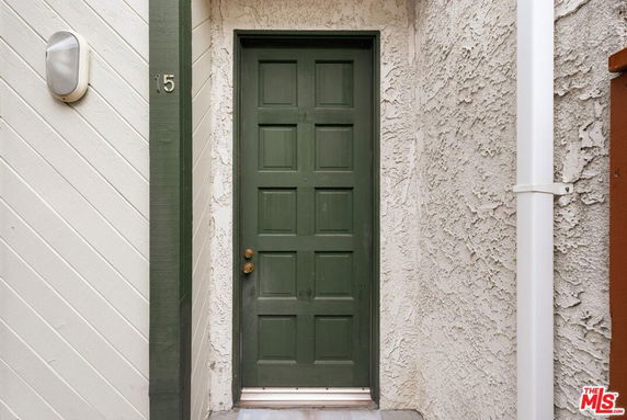Front view of a building entrance with a green door.