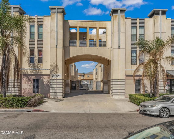 Front view of a multi-story building with an archway entrance.