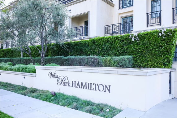 Front view of a multi-story building with balconies and a sign reading 'Villas Park Hamilton.'