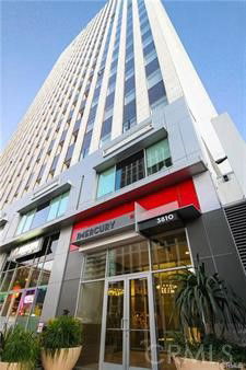 Front view of a tall commercial building with glass entrance.