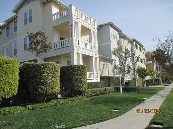Front view of a multi-story residential building with balconies.