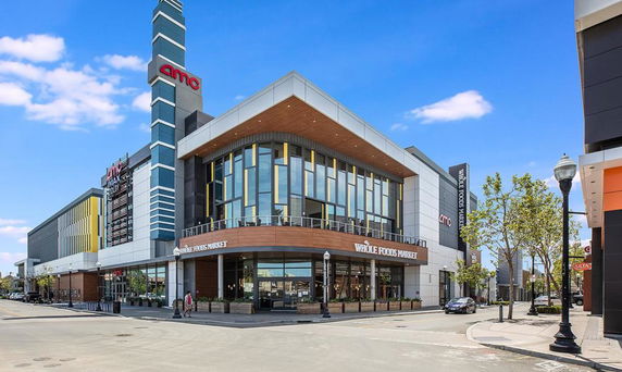 Front view of a commercial building with large glass windows and distinctive architectural design.