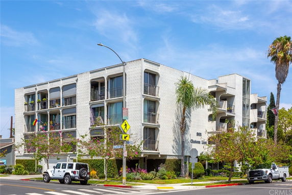 Front view of a multi-story residential building with balconies.